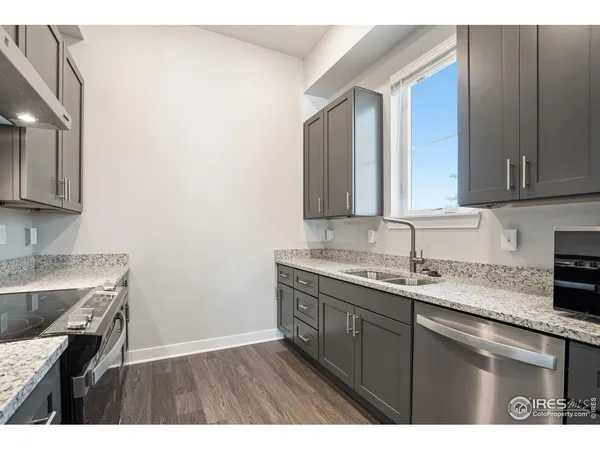 a kitchen with a sink dishwasher and cabinets