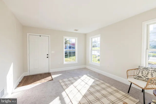 a view of a room with window and furniture