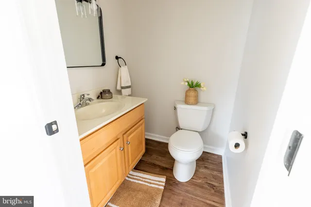 a bathroom with a sink toilet and a mirror