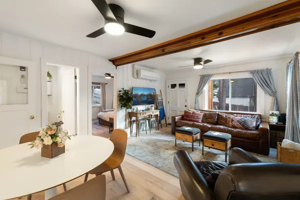 a living room with furniture and a chandelier