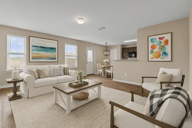 a living room with furniture and painting on the wall