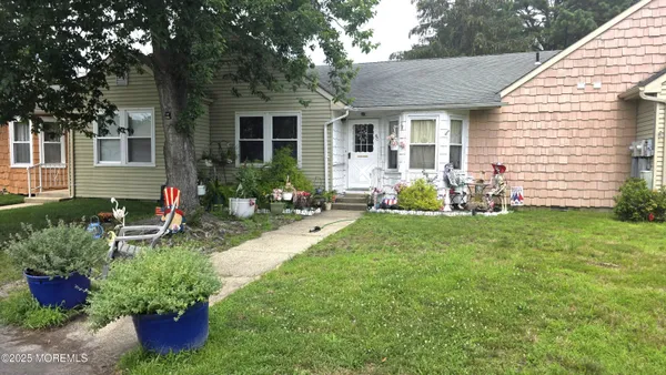 a front view of a house with garden and porch