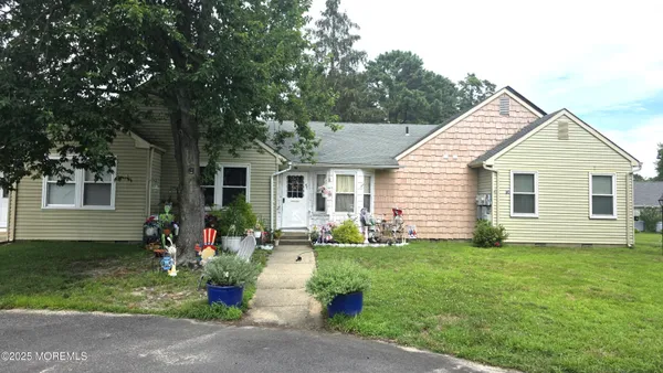 a front view of house with yard and green space