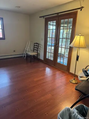 a view of a room with wooden floor and windows