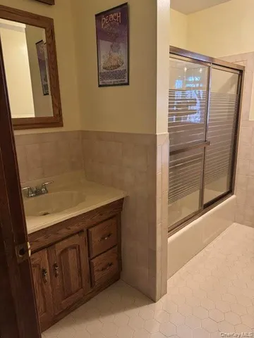 a bathroom with a sink a mirror and a shower