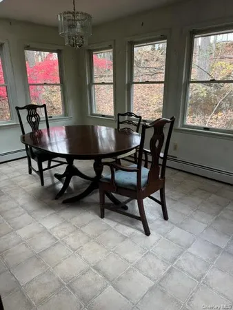 a view of a dining room with furniture and a chandelier