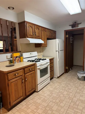 a kitchen with stainless steel appliances a refrigerator sink and cabinets