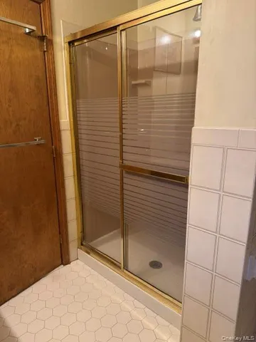 a bathroom with a glass shower door