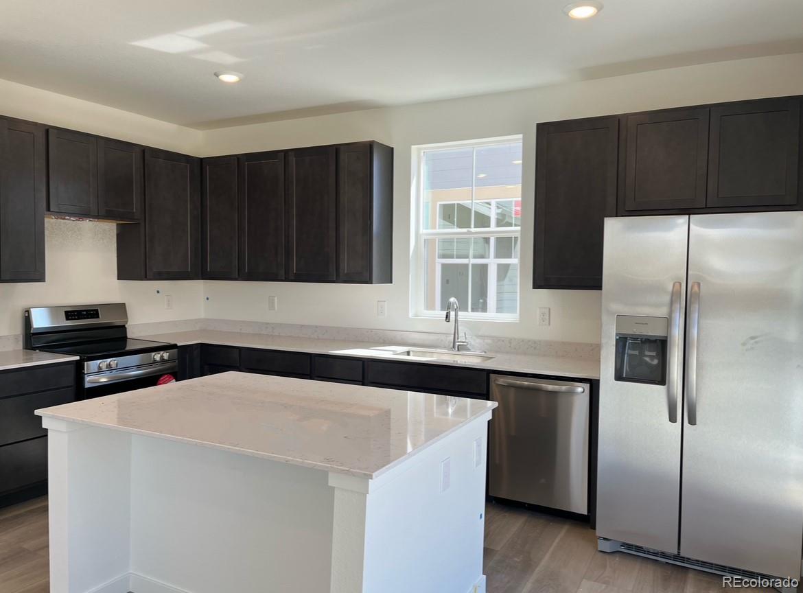808 Yankee Boy Loop Elizabeth, CO 80107 - Photo 2 of 12 a kitchen with a sink a refrigerator and cabinets