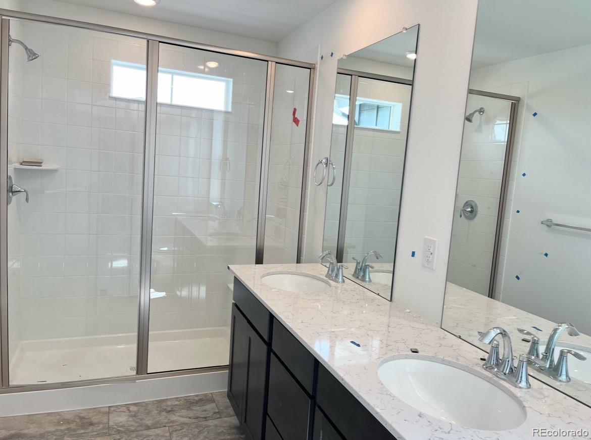 808 Yankee Boy Loop Elizabeth, CO 80107 - Photo 3 of 12 a bathroom with a double vanity sink mirror and shower