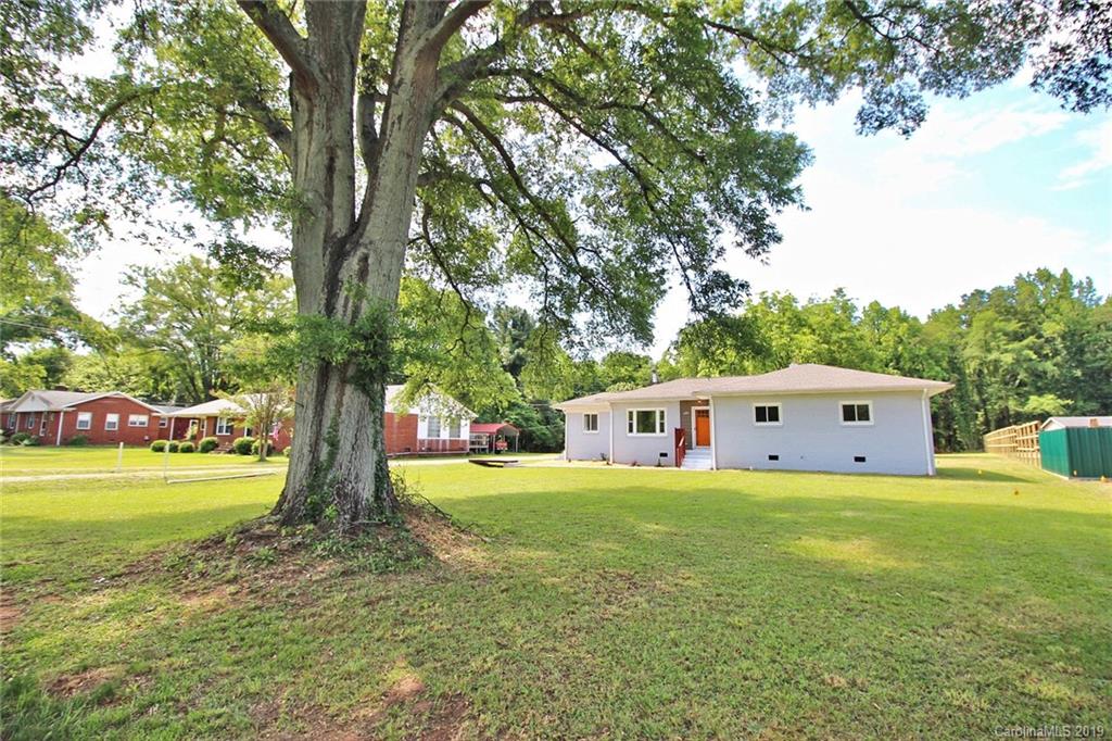 6201 Tuckaseegee Road Charlotte, NC 28208 - Photo 3 of 21 a view of a house with yard and sitting area in a yard