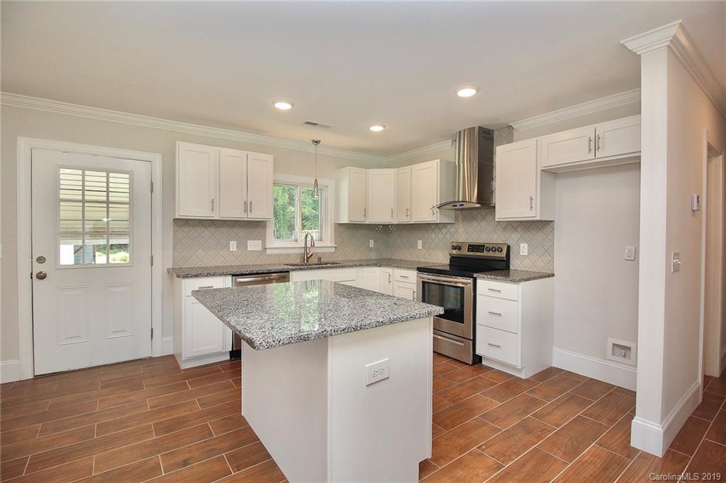 6201 Tuckaseegee Road Charlotte, NC 28208 - Photo 6 of 21 a kitchen with stainless steel appliances granite countertop a stove a sink and a refrigerator