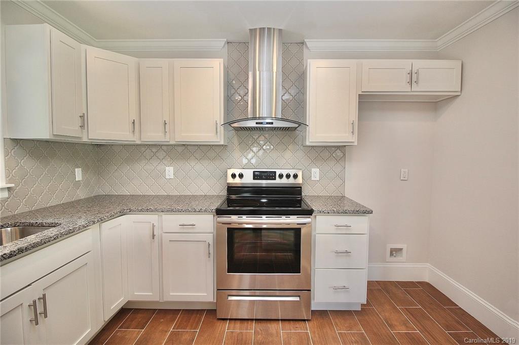 6201 Tuckaseegee Road Charlotte, NC 28208 - Photo 8 of 21 a kitchen with stainless steel appliances granite countertop white cabinets and a stove