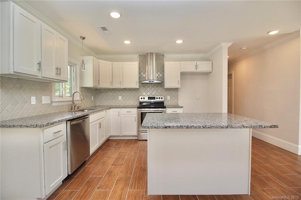 6201 Tuckaseegee Road Charlotte, NC 28208 - Photo 9 of 21 a kitchen with stainless steel appliances granite countertop a stove a sink and a refrigerator