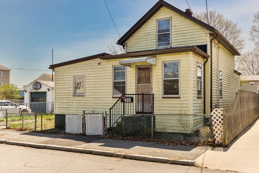 a view of a house with a small backyard