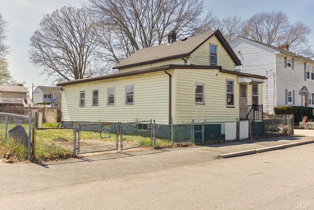 495 Chicago Street Fall River, MA 02721 - Photo 2 of 26 a front view of a house with a yard and garage