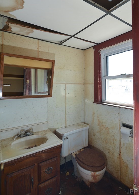 495 Chicago Street Fall River, MA 02721 - Photo 22 of 26 a bathroom with a granite countertop toilet sink and mirror