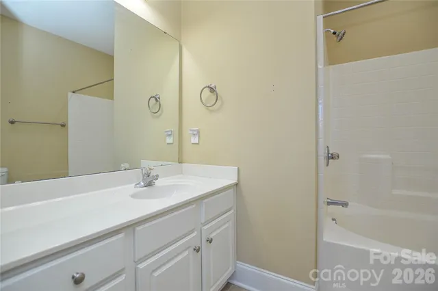 a bathroom with a sink a shower and a mirror