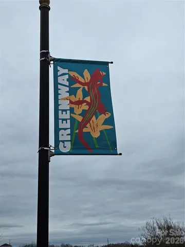 a view of backyard with wooden fence