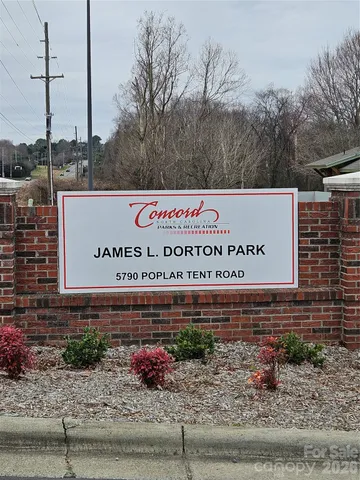 a wooden bench sitting in front of a building