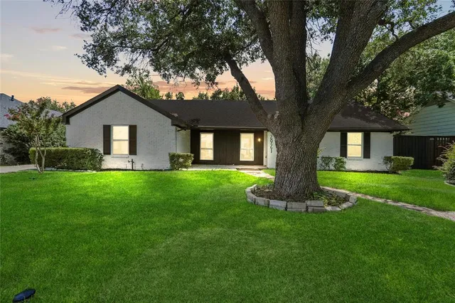 a front view of house with a garden
