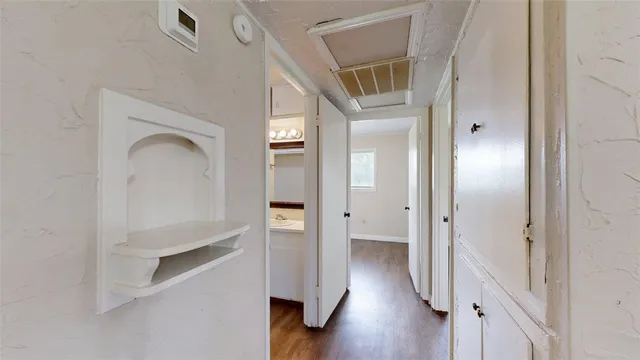 a view of a hallway with wooden floor