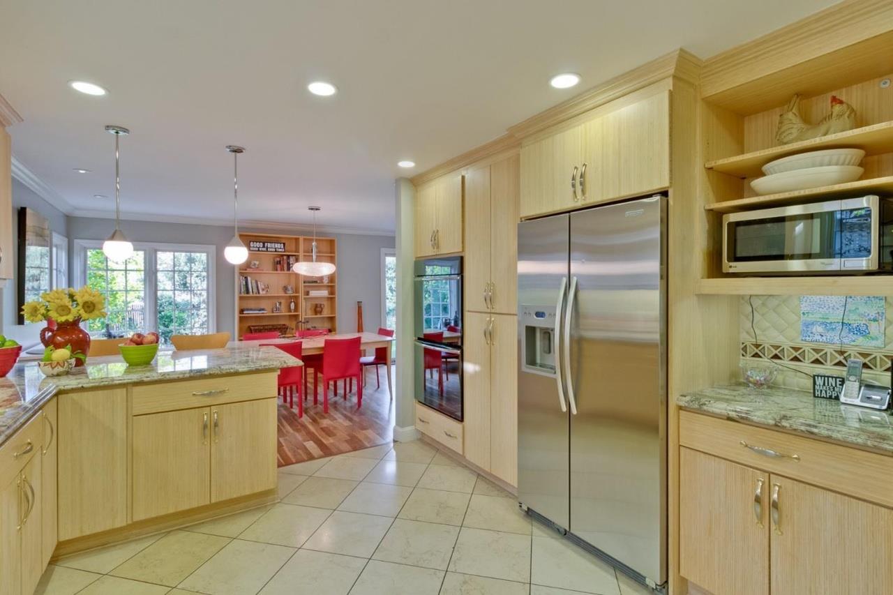 1909 Ray Drive Burlingame, CA 94010 - Photo 4 of 10 a kitchen with stainless steel appliances granite countertop a sink and a refrigerator