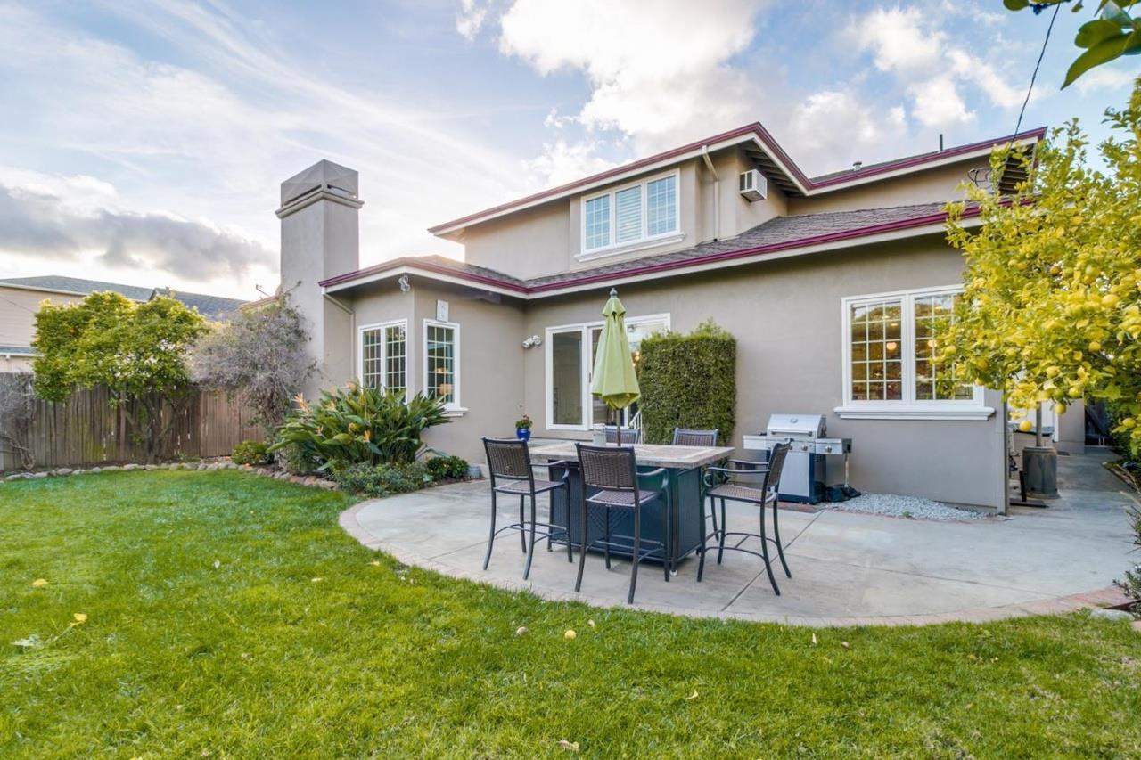 1909 Ray Drive Burlingame, CA 94010 - Photo 10 of 10 a patio with couches table and chairs and potted plants