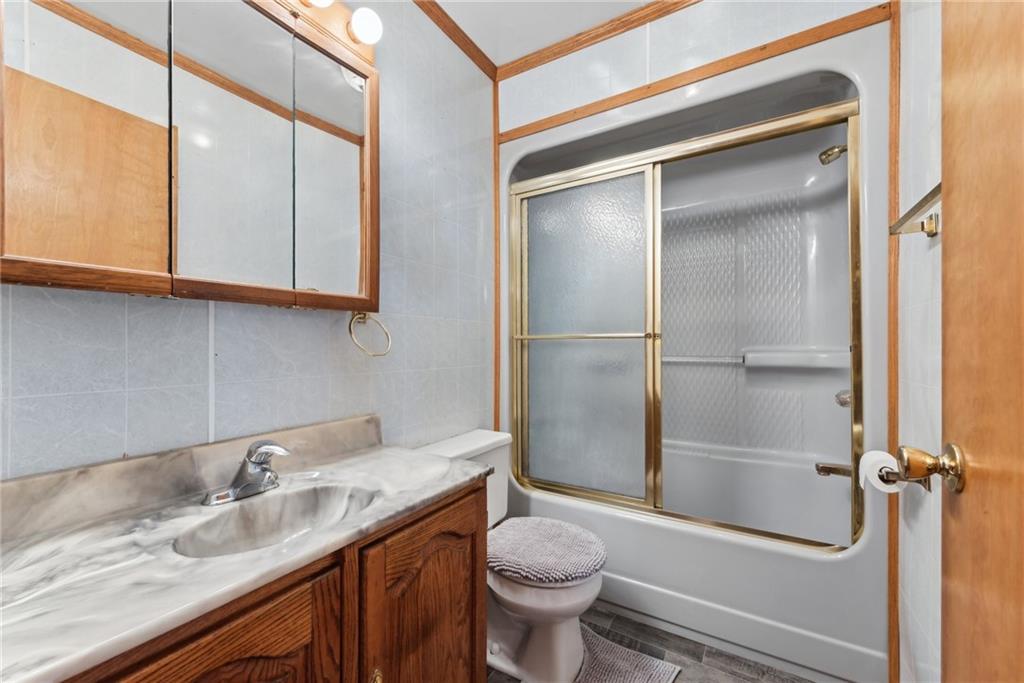 124 Hampton Road Mill Run, PA 15464 - Photo 16 of 32 a bathroom with a granite countertop sink toilet and shower