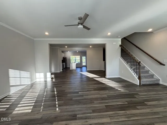 a view of entryway and hall with wooden floor