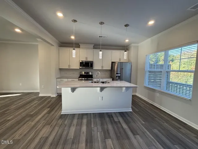 a view of kitchen with sink microwave and refrigerator