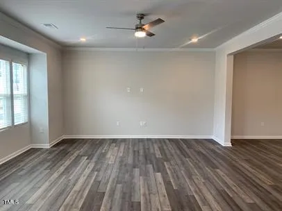 wooden floor in an empty room with a window