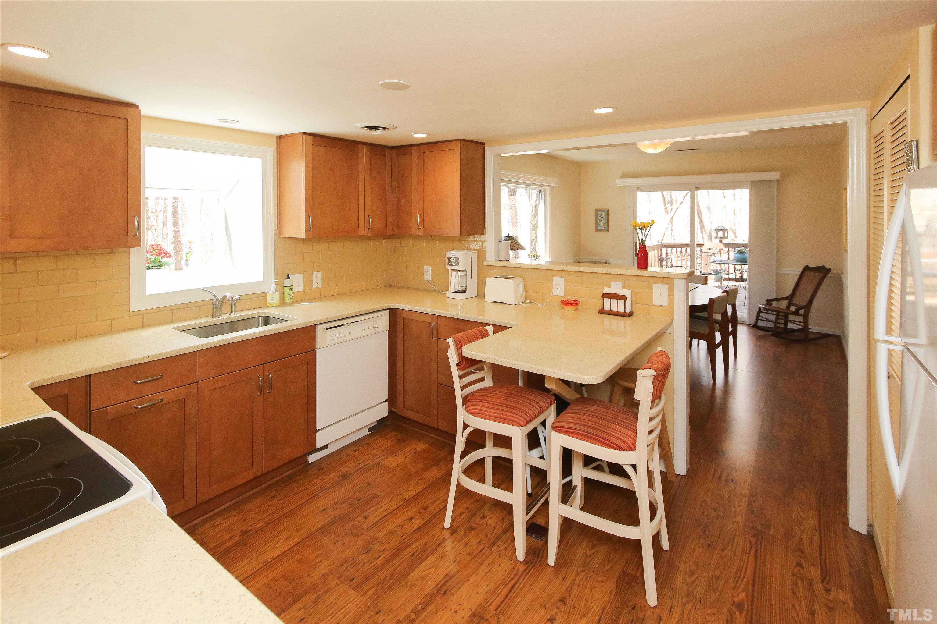 3084 Colony Road, Unit 3084A Durham, NC 27705 - Photo 4 of 16 a kitchen with a dining table chairs and wooden floor
