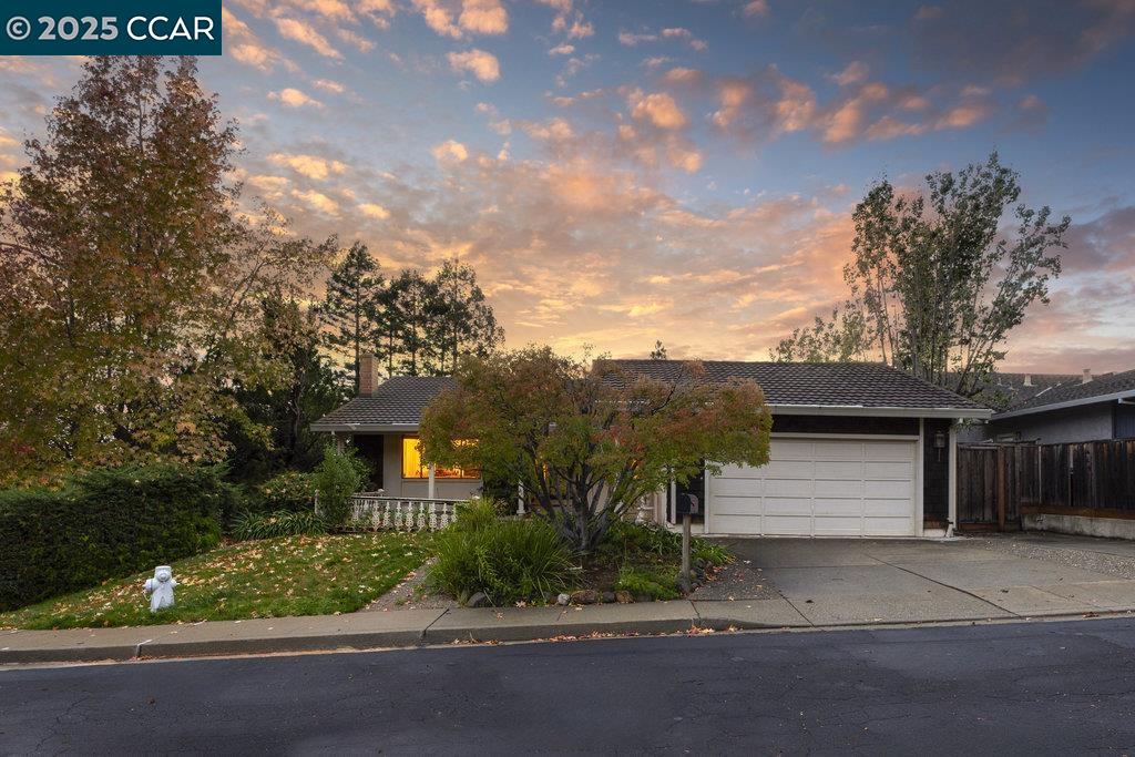 740 Sunflower Court Concord, CA 94518 - Photo 4 of 13 a front view of a house with a yard and garage