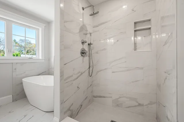 a bathroom with a bathtub and shower