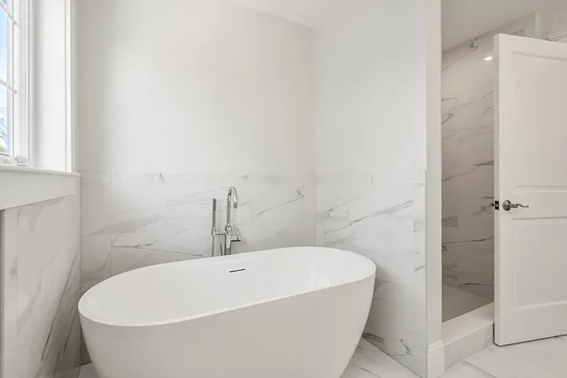 a white bath tub sitting in a bathroom