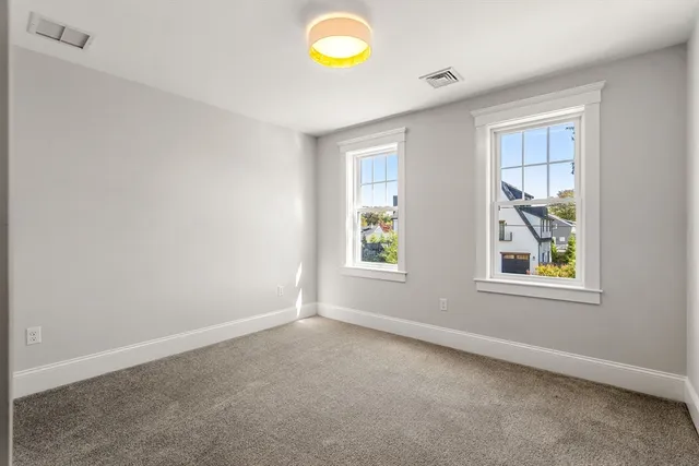 an empty room with window and mirror