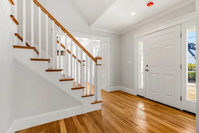 a view of entryway and hall with wooden floor