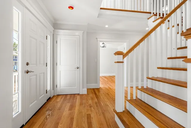 a view of entryway with wooden floor and stairs