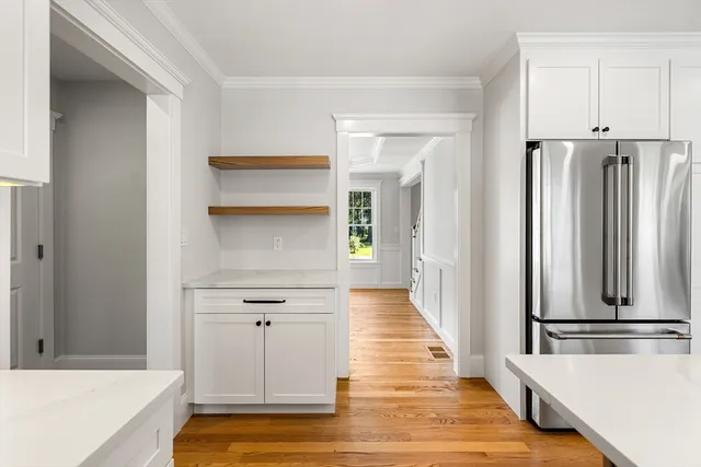 a view of a kitchen with wooden floor and electronic appliances