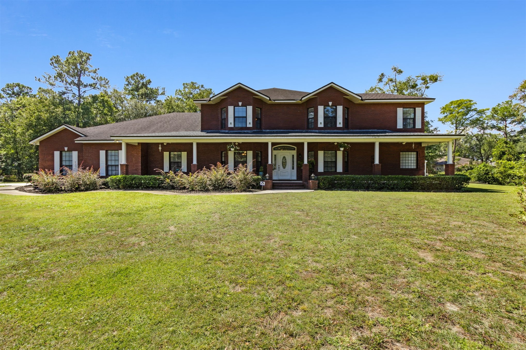 87377 Raddin Road Yulee, FL 32097 - Photo 4 of 75 a front view of residential houses with yard and green space