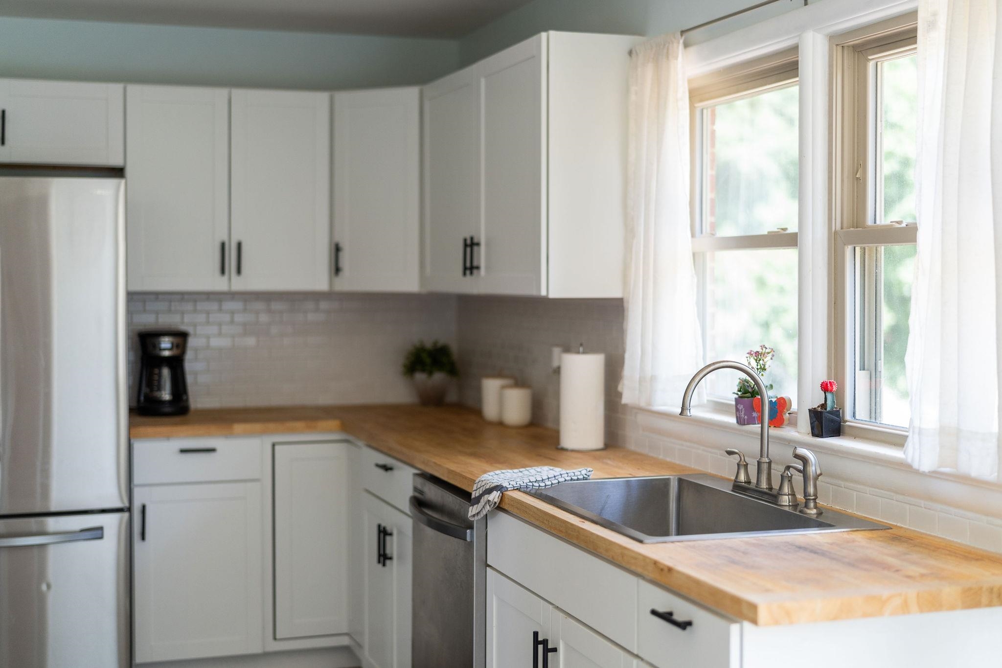 1064 Ladd Road Waynesboro, VA 22980 - Photo 13 of 51 a kitchen with white cabinets and a sink