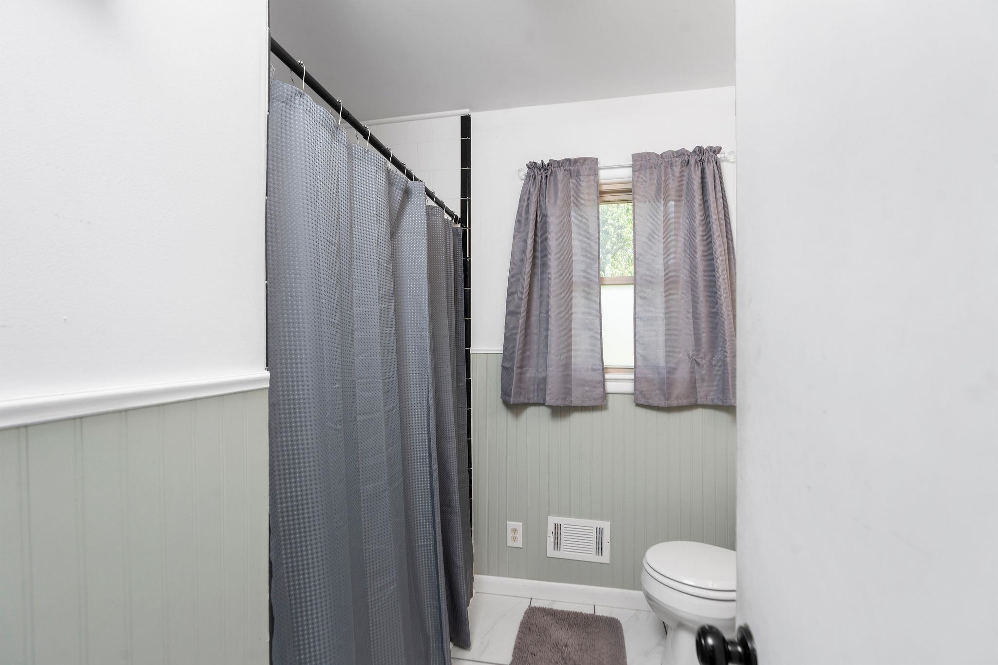 1064 Ladd Road Waynesboro, VA 22980 - Photo 16 of 51 a bathroom with a toilet a sink and a mirror