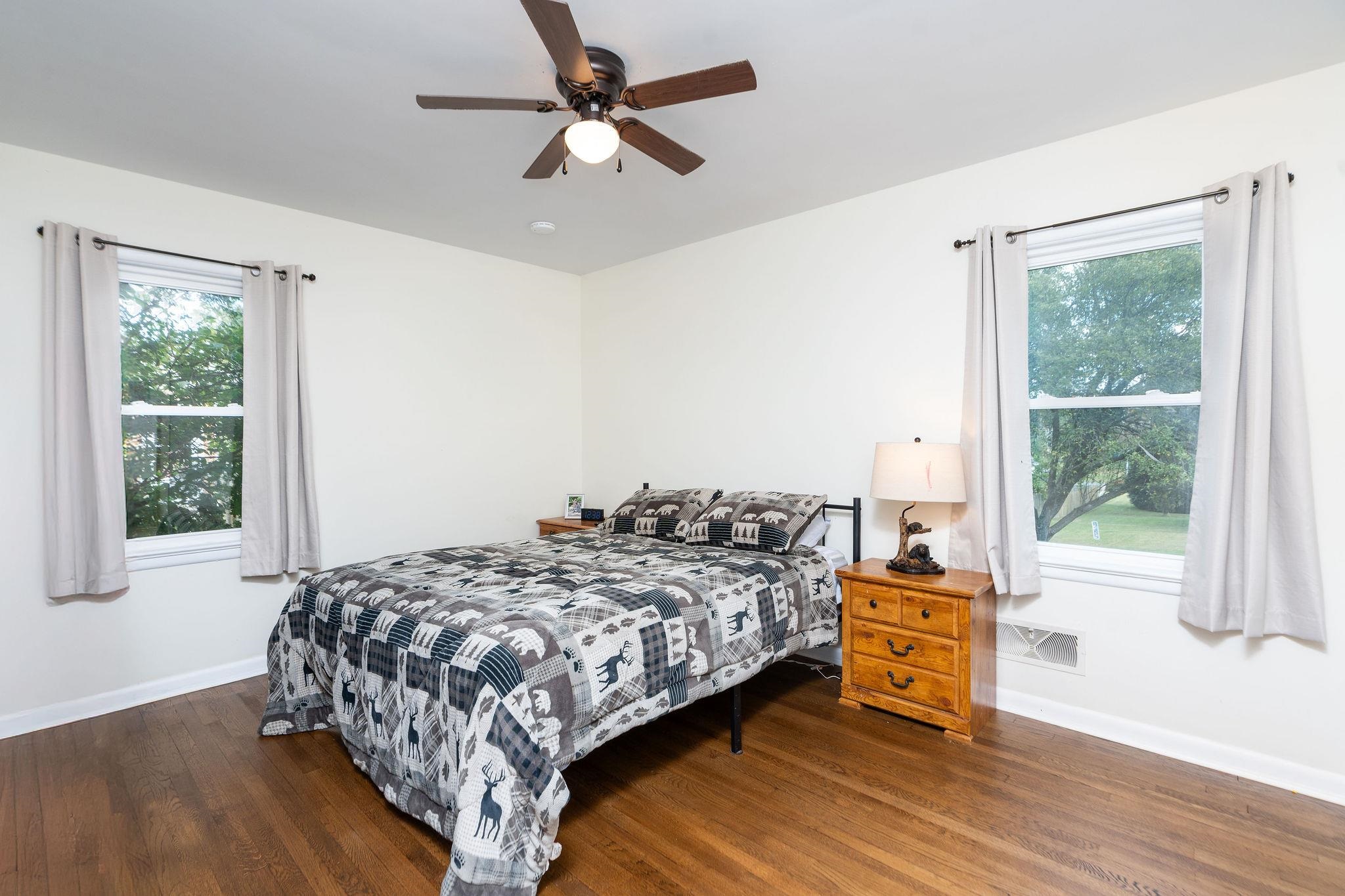 1064 Ladd Road Waynesboro, VA 22980 - Photo 17 of 51 a bedroom with a bed a chandelier and a window