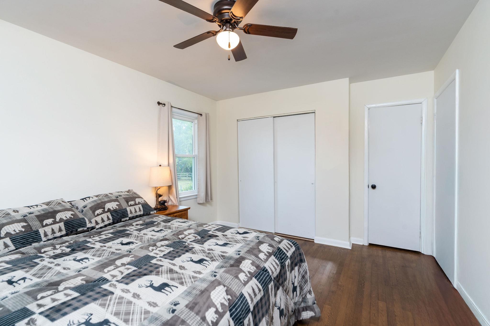 1064 Ladd Road Waynesboro, VA 22980 - Photo 18 of 51 a bedroom with a bed and a chandelier
