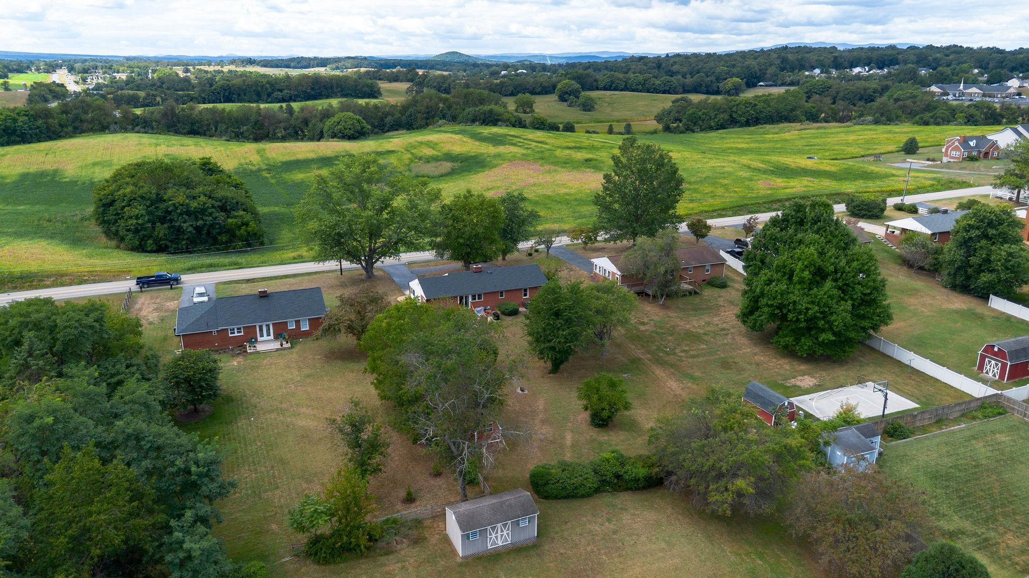 1064 Ladd Road Waynesboro, VA 22980 - Photo 44 of 51 an aerial view of green landscape with trees houses and mountain view