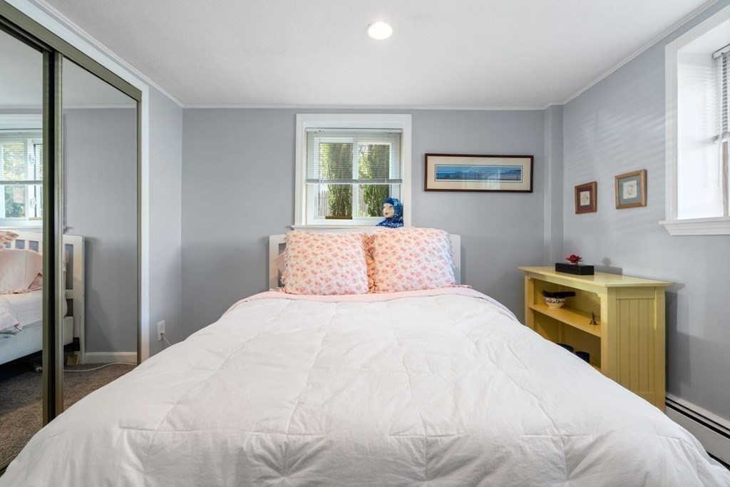 64 Bryon Road, Unit B641 Boston, MA 02467 - Photo 13 of 26 a bedroom with a bed and a window