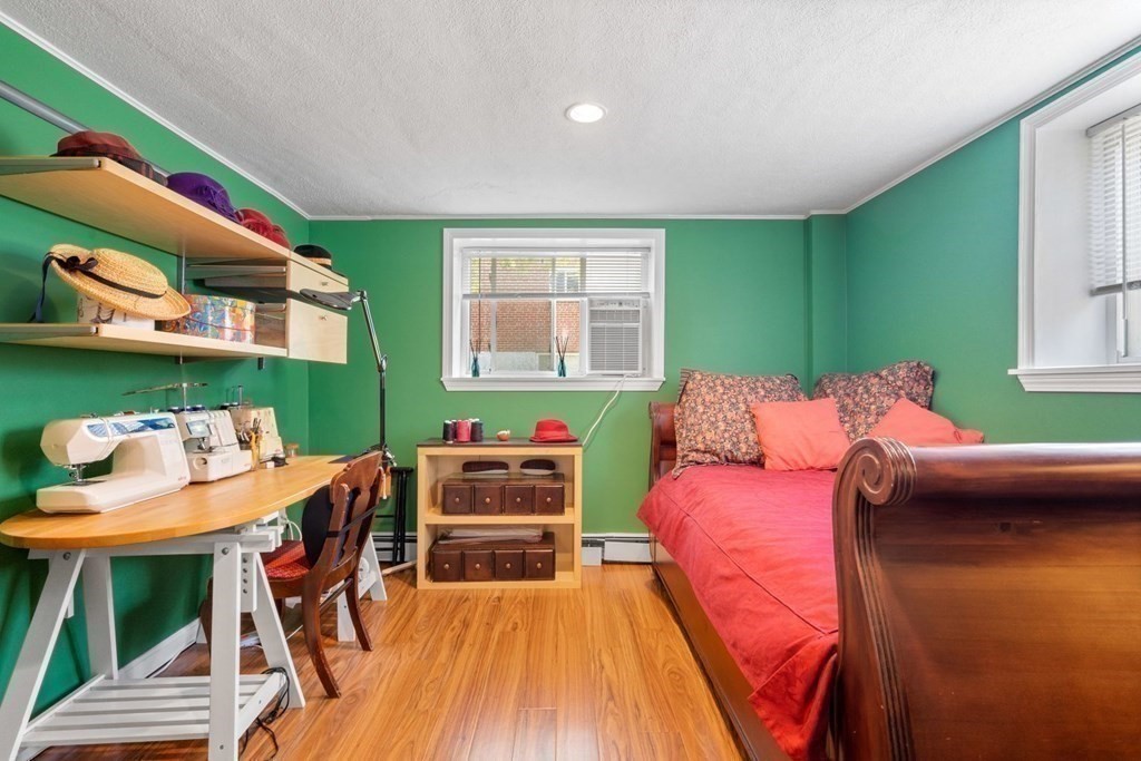 64 Bryon Road, Unit B641 Boston, MA 02467 - Photo 15 of 26 a workspace with furniture and a wooden floor
