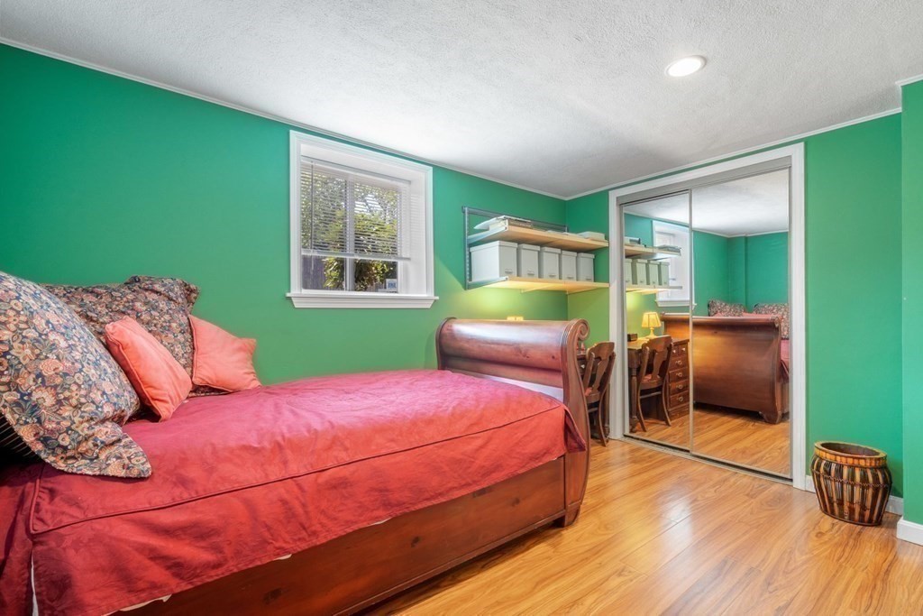 64 Bryon Road, Unit B641 Boston, MA 02467 - Photo 16 of 26 a bedroom with a bed and large windows