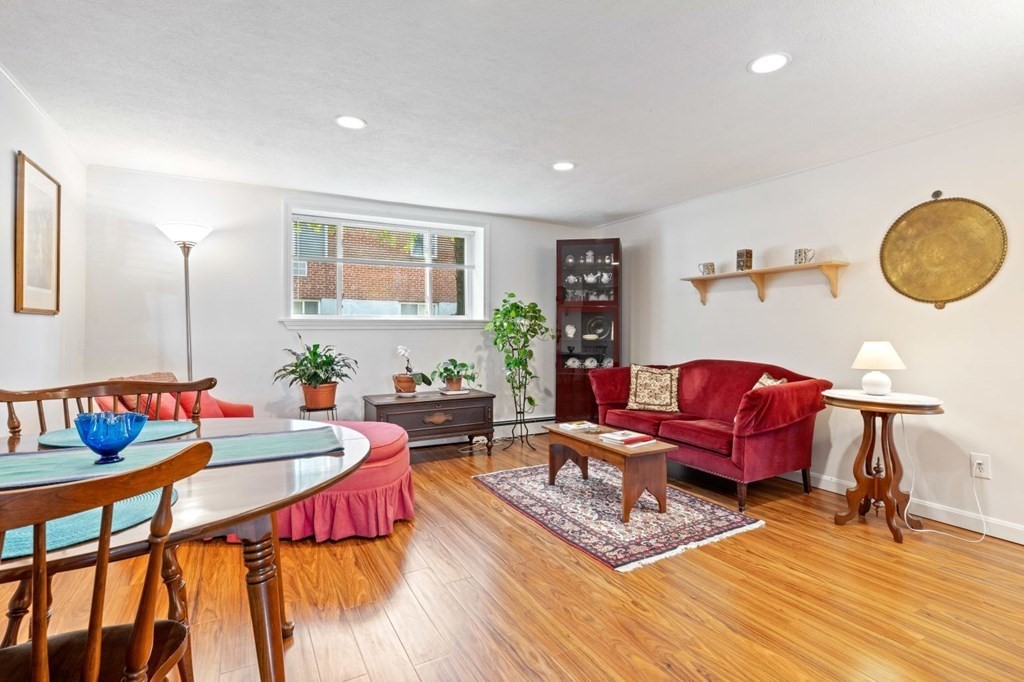 64 Bryon Road, Unit B641 Boston, MA 02467 - Photo 4 of 26 a living room with furniture and a wooden floor